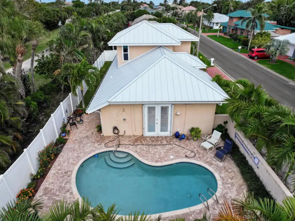 Coastal Florida home with durable metal roof installed by DC Roofing Inc.