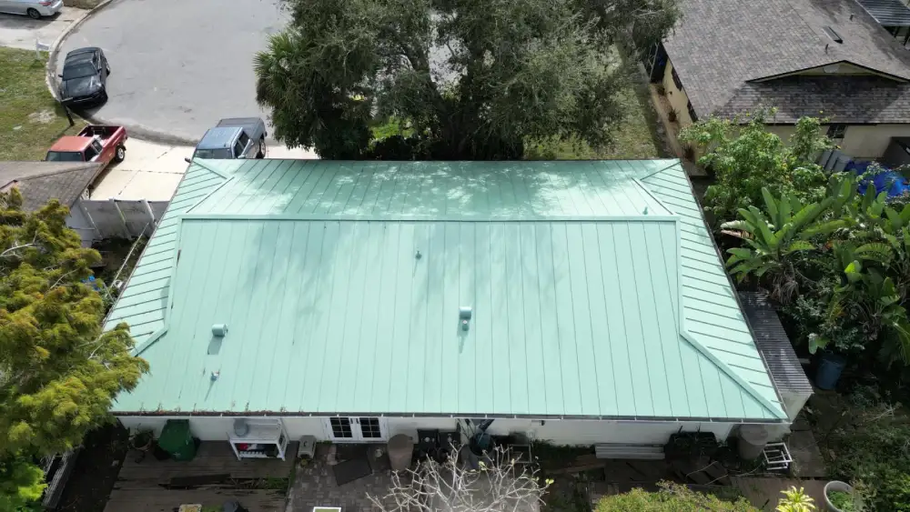 Green standing seam metal roof on a Florida coastal residence