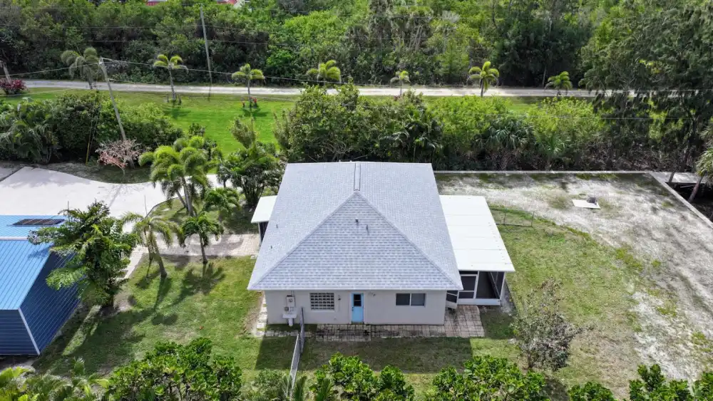 Shingle roof beside lush greenery illustrating Melbourne home maintenance needs